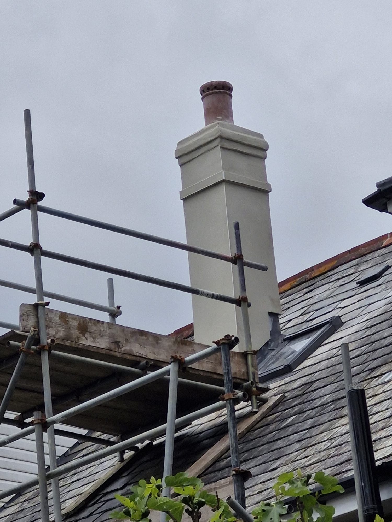 Completed chimney rebuild with new render and pot